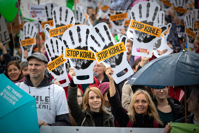 Demonstranten halten Schilder mit Stop Kohle hoch auf einer Demo für den Kohleausstieg